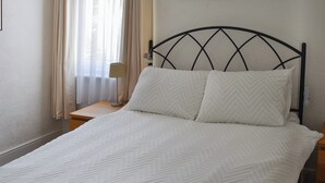 A neatly made bed with a white herringbone-patterned bedspread and two white pillows. - 6 bedroom accommodation in Clacton on Sea (Clacton on Sea)