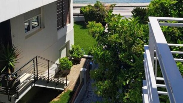 A modern building with a balcony overlooking a body of water. - Amare Luxury Living Volos (Volos)