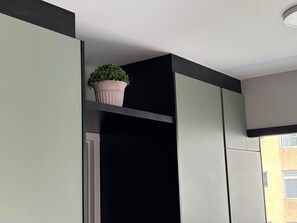 A modern interior with a black shelf holding a potted plant. - Studio Sao Paulo PUC Allianz Park 701WB (São Paulo)