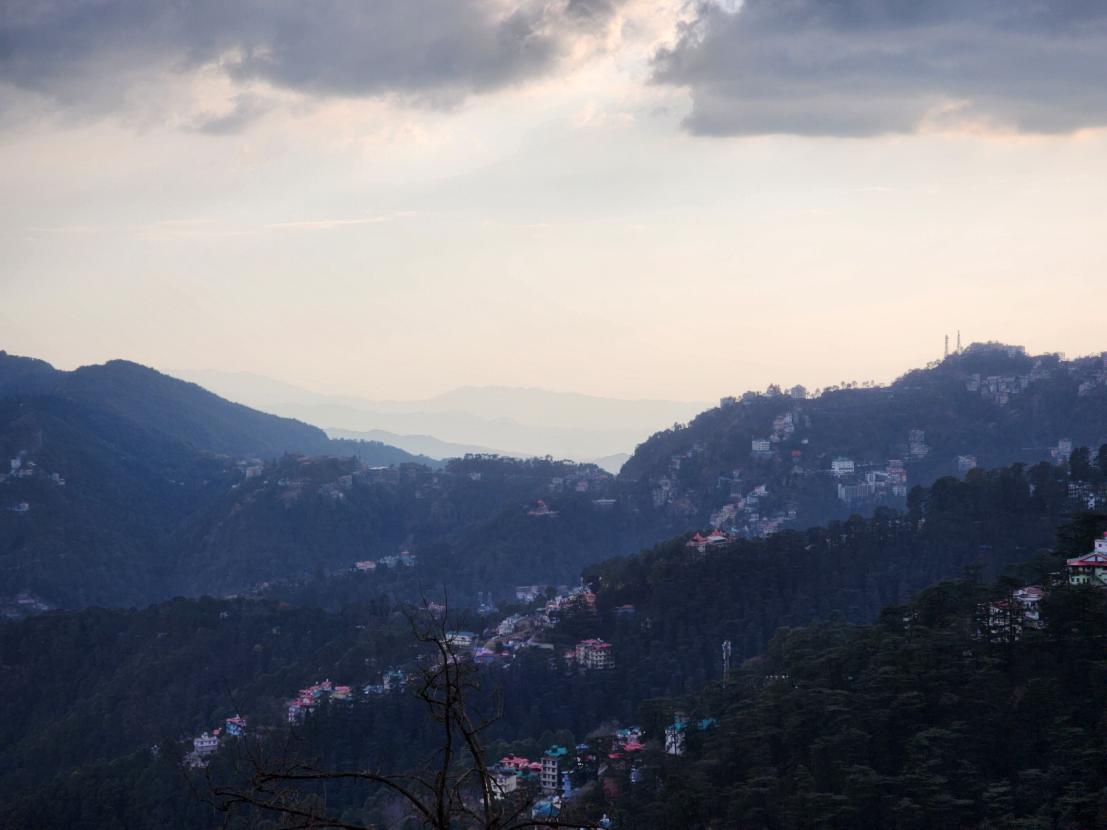 A mountainous landscape with scattered buildings.