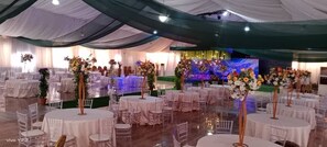 A banquet hall with round tables covered in white tablecloths, arranged in rows. - Blue Moon Beach Hotel and Resort Lekki Lagos (Lagos)