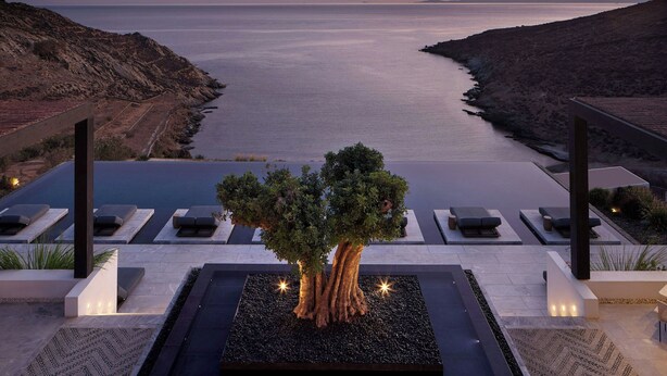 A modern resort with a infinity pool, a large tree, and a view of the sea at sunset. - Odera, Tinos, Autograph Collection (Tinos)