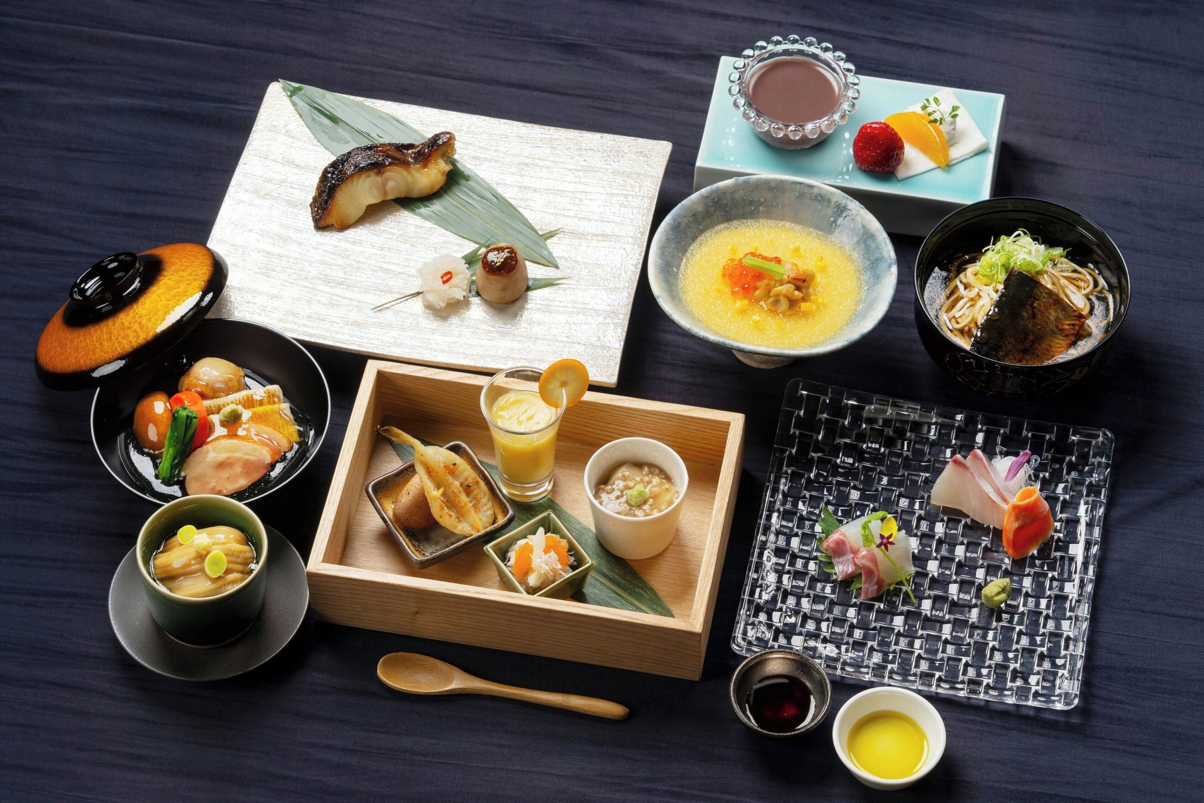 A variety of Japanese dishes arranged on a wooden tray.