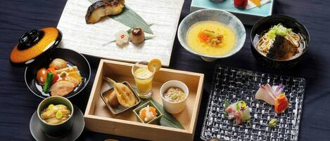 A variety of Japanese dishes arranged on a wooden tray.