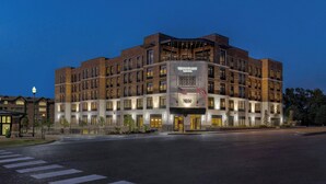 A multi-story hotel with a prominent entrance and a large sign displaying the name and address. - Towneplace Suites By Marriott Memphis Germantown (Germantown)