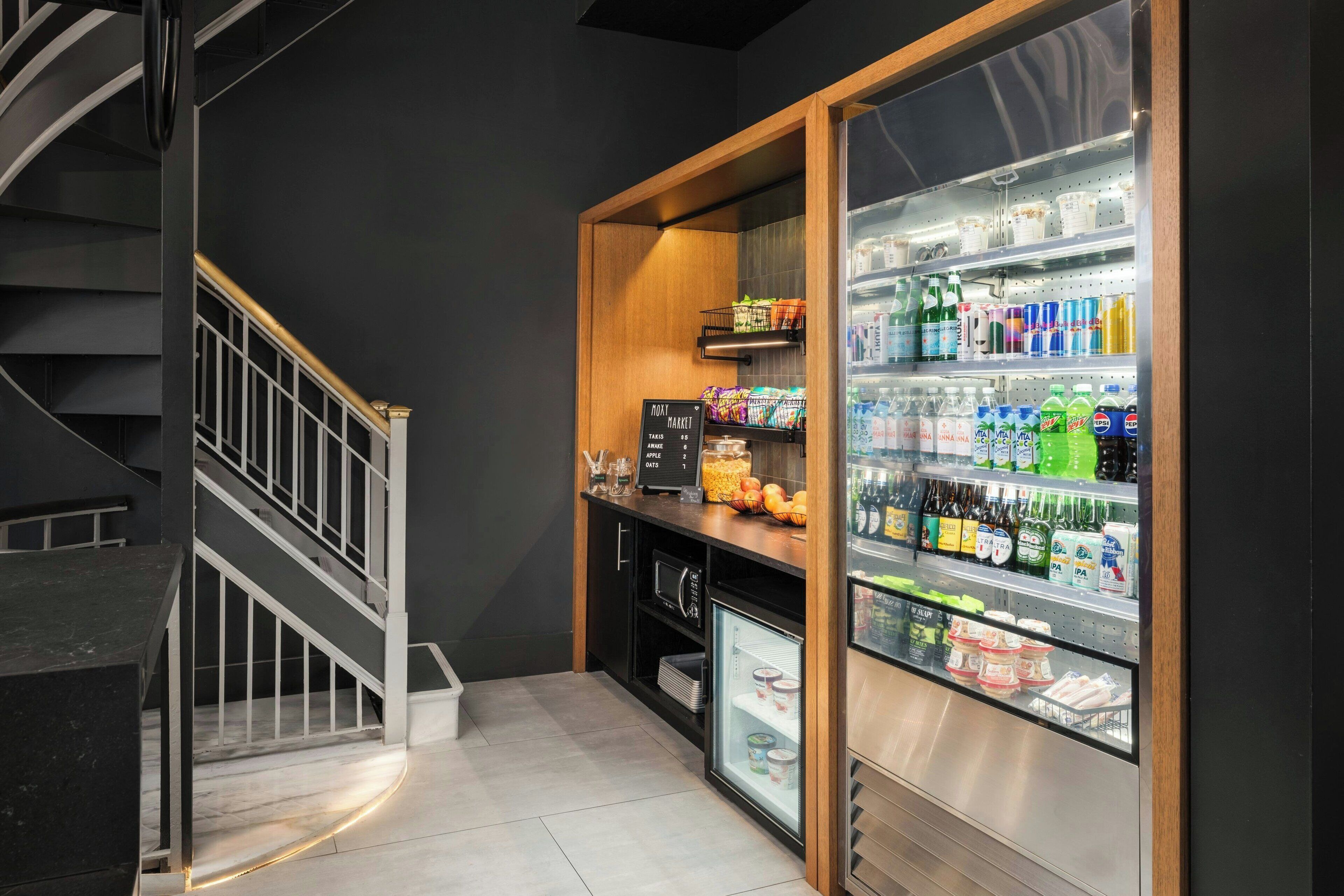 A modern kitchen with a built-in refrigerator, a microwave, and a wooden countertop.