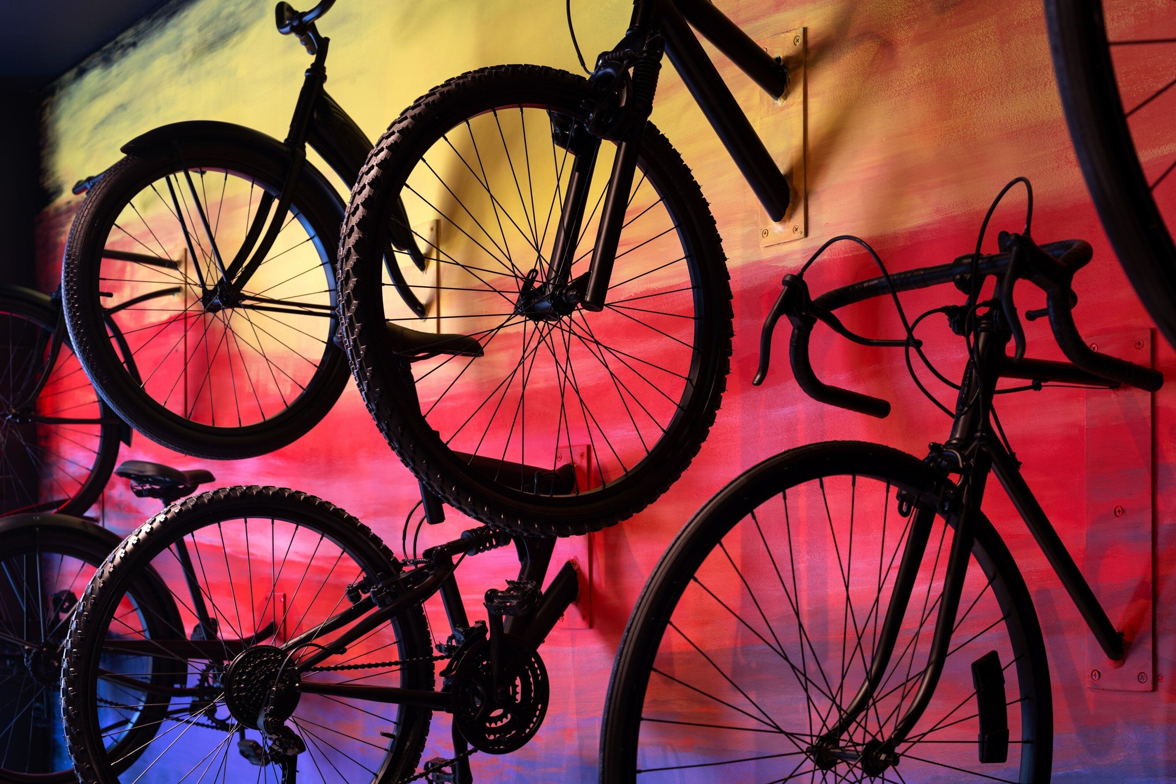 A wall with a colorful mural featuring bicycles.