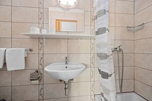Shower, hair dryer, towels, toilet paper