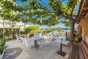 Relax in a shaded patio area with comfortable seating and scenic views.
