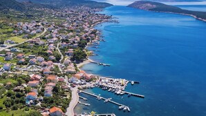 An aerial view of a coastal town with residential buildings, a marina, and a clear blue sea. - Spectacular Sea View, Mooring - Jurica (Petra) (Rab)