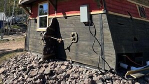 A building with a rustic exterior, featuring a large window and a door. - Pirate Ship - Deluxe Cabin #3 on map (Bayfield)