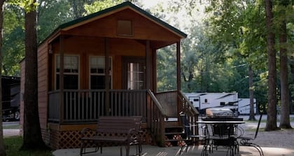 Deluxe Cabin (w/ Bathroom) - Deluxe Cabin (w/ Bathroom) Better than a motel! Enjoy camping in comfort! Kitchen with stove top and full size fridge with dishes pots included. Full bathroom with shower. Cable TV DVD player. Gas grill on your own concre