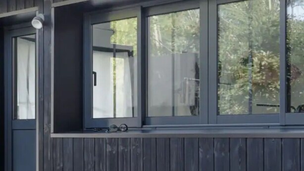 A building with large windows and a wooden table outside. - PYLA: Nice creative studio 200 m from the beach (La Teste-de-Buch)