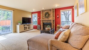 A living room with a fireplace, a television, and a sofa.