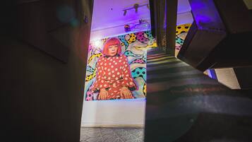 A staircase with a colorful mural on the wall.