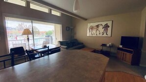 A spacious living area with a large kitchen island, a dining table, and a seating area. - #188 Condo near large pool & shuttle to Gorge Amp-book separately (Quincy)