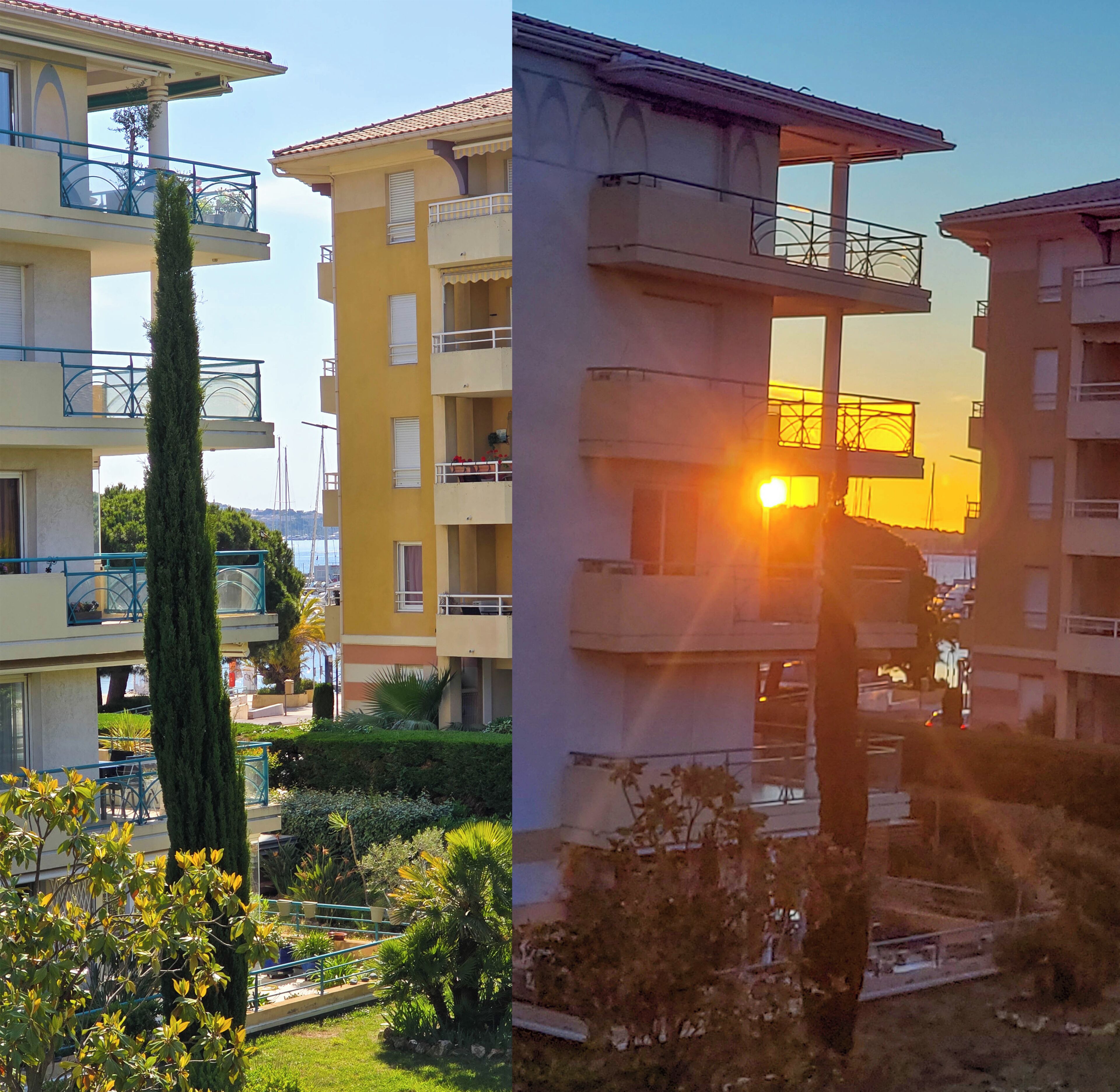A multi-story residential building with balconies, a garden area, and a clear sky.