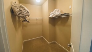 A small, carpeted closet with a hanging rack and shelves for storage. - A08-Sharp River/Golf Course view near pool/hot tub (Quincy)