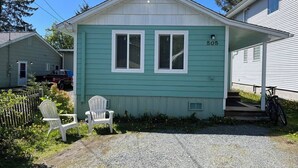 A single-story house with a green exterior, numbered 505, featuring two windows and a porch area. - Cozy Downtown Sitka Home, Car Rental Option (Sitka)