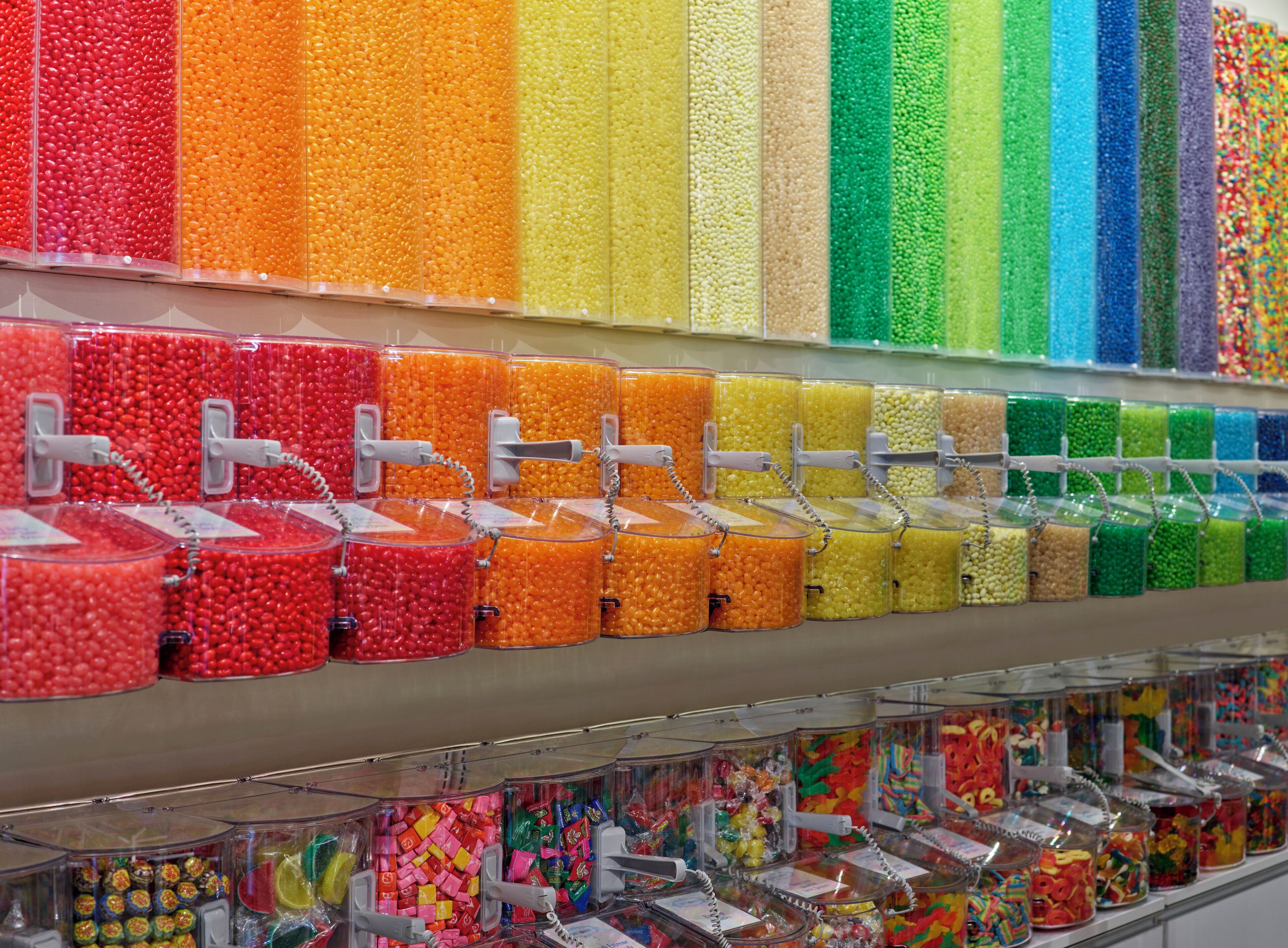 A candy store with various colorful candies in transparent containers.