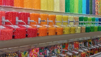 A candy store with various colorful candies in transparent containers.