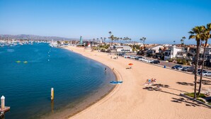 A coastal beach with a marina, palm trees, and beachside buildings. - 7 Bed Waterfront W/Rooftop pool & hot tub stunning 360-degree bay & beach view (Newport Beach)
