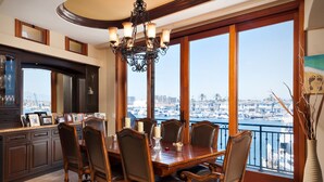 A dining area with a view of a marina. - 7 Bed Waterfront W/Rooftop pool & hot tub stunning 360-degree bay & beach view (Newport Beach)