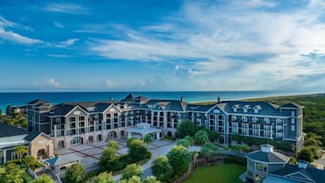 A majestic aerial view of a sprawling beachfront property, where luxury meets the horizon.