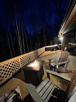 deck with the hot tub and propane fire pit