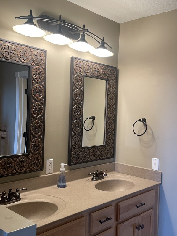 A bathroom with two sinks, a mirror with ornate frames, a towel ring, and a soap dispenser. - Downtown loft apartment with rooftop balcony (Warsaw)