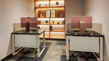 A modern office space with two desks, a bookshelf, and a decorative wall panel.