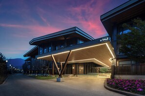 A modern hotel with a prominent entrance canopy and a sign that reads 'Well'. - EVEN Chongli by IHG (Zhangjiakou)