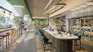 A modern restaurant with a long counter, bar stools, and a kitchen area visible. - EVEN Chongli by IHG (Zhangjiakou)