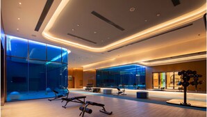 A modern gym with exercise equipment, large windows, and a well-lit interior. - EVEN Chongli by IHG (Zhangjiakou)
