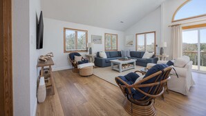 A spacious living room with a high ceiling, large windows, and a view of the outdoors. - 4670 - Salted Skyline - Dog-Friendly Coastal Escape Near the Beach (Southern Shores)