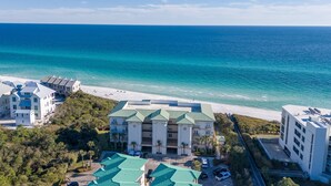 A beachfront hotel with multiple buildings, a parking area, and a view of the ocean. - "Beach DNA" at The Legacy 203 in Seagrove Beach | My Beach Getaways (Santa Rosa Beach)