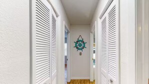 A hallway with white doors and a wooden floor. - Waterfront home with direct gulf access   (Hernando Beach)
