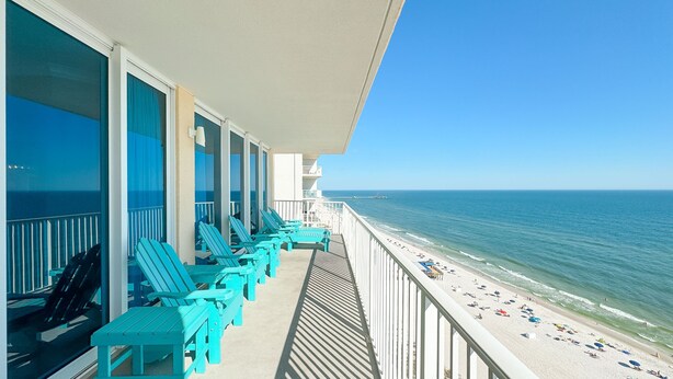 A balcony with turquoise chairs overlooking a beach. - BEACHFRONT, ZERO ENTRY POOL, PRIVATE BALCONY! (Gulf Shores)