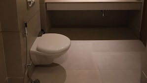 A modern bathroom with a toilet, sink, and shower. - Surestay By Best Western Lucknow (Lucknow)