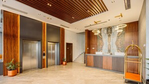 A modern lobby with a reception desk, elevators, and a staircase. - Best Western Plus Batumi (Batumi)