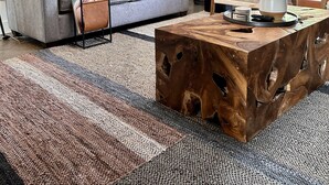 A living room with a gray sofa, a wooden coffee table, a black metal shelf, and a large window with curtains. - Birch Bayside Retreat - AC, Pet Friendly & Close to the Beach! Luxury 2 Bedroom (Blaine)