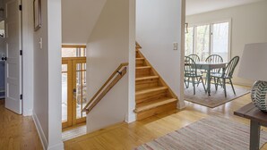 A staircase leading to a dining area with a table and chairs. - Heavenfell | Spacious Montreat Home | 1 Mile from Lake Susan & Conference Center! (Montreat)