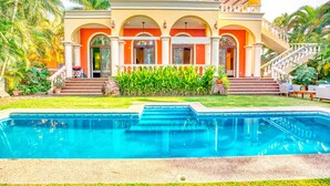 A large, two-story building with a swimming pool in front. - Gorgeous Hacienda-style, private Casa de Paz, with 24-hour gated security (Bucerias)