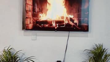 Comfort House | Living area | 55-inch Smart TV with digital channels, video-game console, Netflix