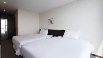 A hotel room with two beds, a large window, and a door leading to a balcony.