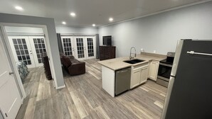 A modern kitchen with a dishwasher, sink, and refrigerator.
