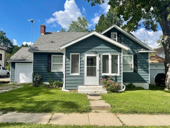 A single-story house with a front porch, a garage, and a small front yard. - Cozy home in historic Hillsdale (Hillsdale)