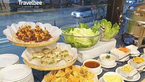 A buffet spread with various dishes including deep fried wonton, salad, and other appetizers. - Travelbee Airport Inn (Lapu-Lapu)