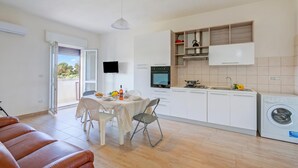 A modern kitchen with white cabinets, a built-in oven, and a washing machine. - Le Bianche Apt 3 - terrace near the Sea, Manduria, Italy (Manduria)