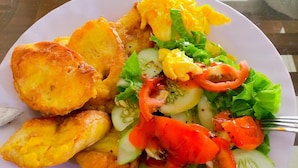 A plate of food with fried items, salad, and vegetables. - Nam Anh Hotel (Phong Nha)